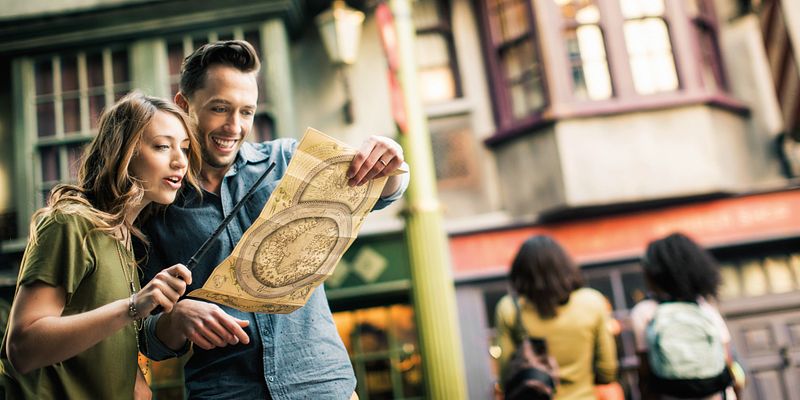 Find Your Way Around The Wizarding World of Harry Potter Couple in Diagon Alley, checking their map in The Wizarding World of Harry Potter.