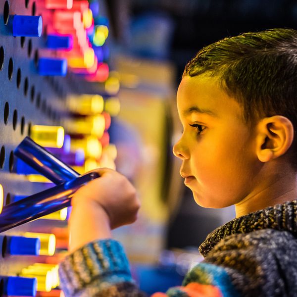 A young boy experiencing the interactive entertainment at WonderWorks Orlando.