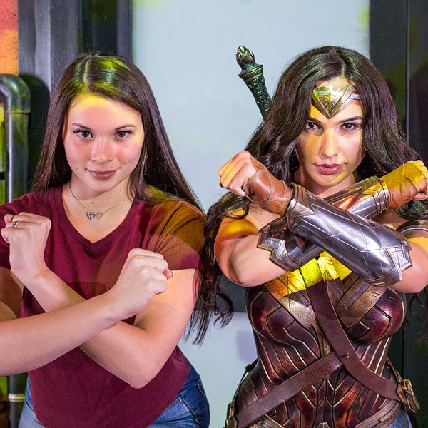 Girl posing with Wonder Woman at Madame Tussauds Orlando
