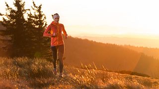 young happy women running in the cold morning with sunshine after sunrise