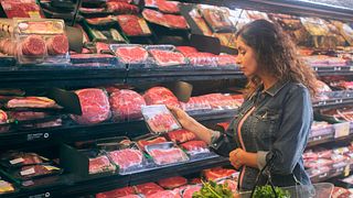 Woman shopping at the open meat case