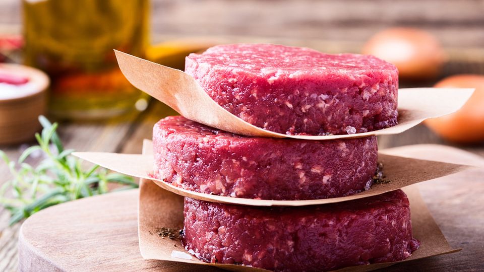 Raw ground beef, round patties for making burgers