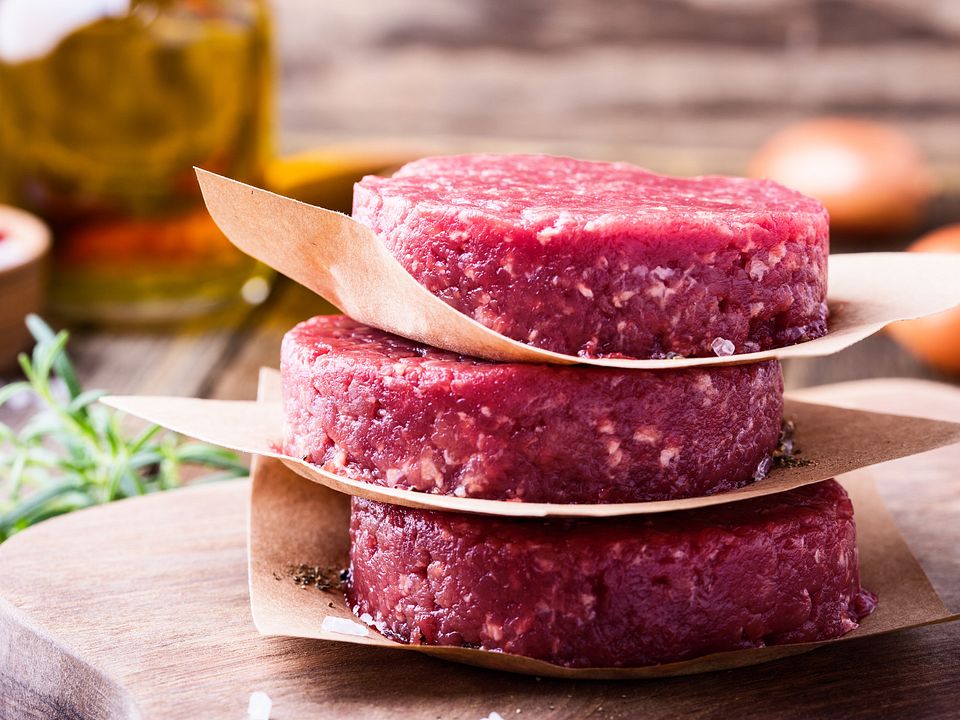 Raw ground beef, round patties for making burgers