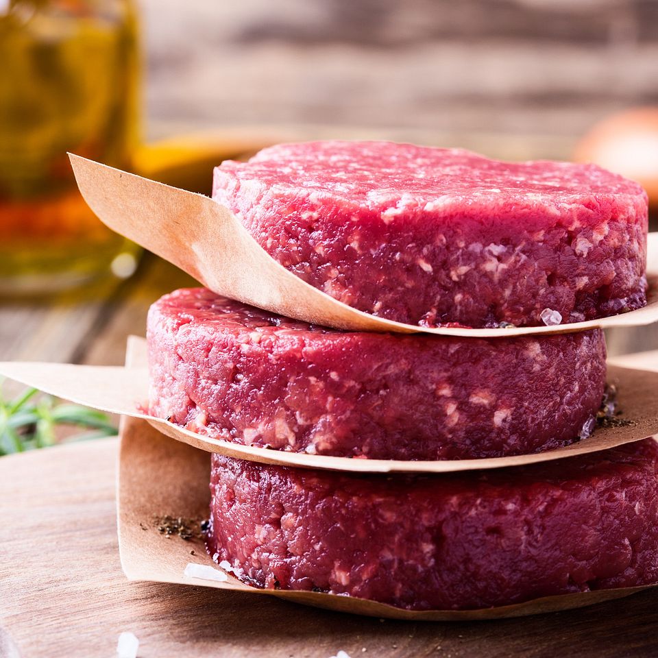 Raw ground beef, round patties for making burgers