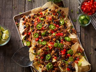 Beef sausage nachos on a wooden table