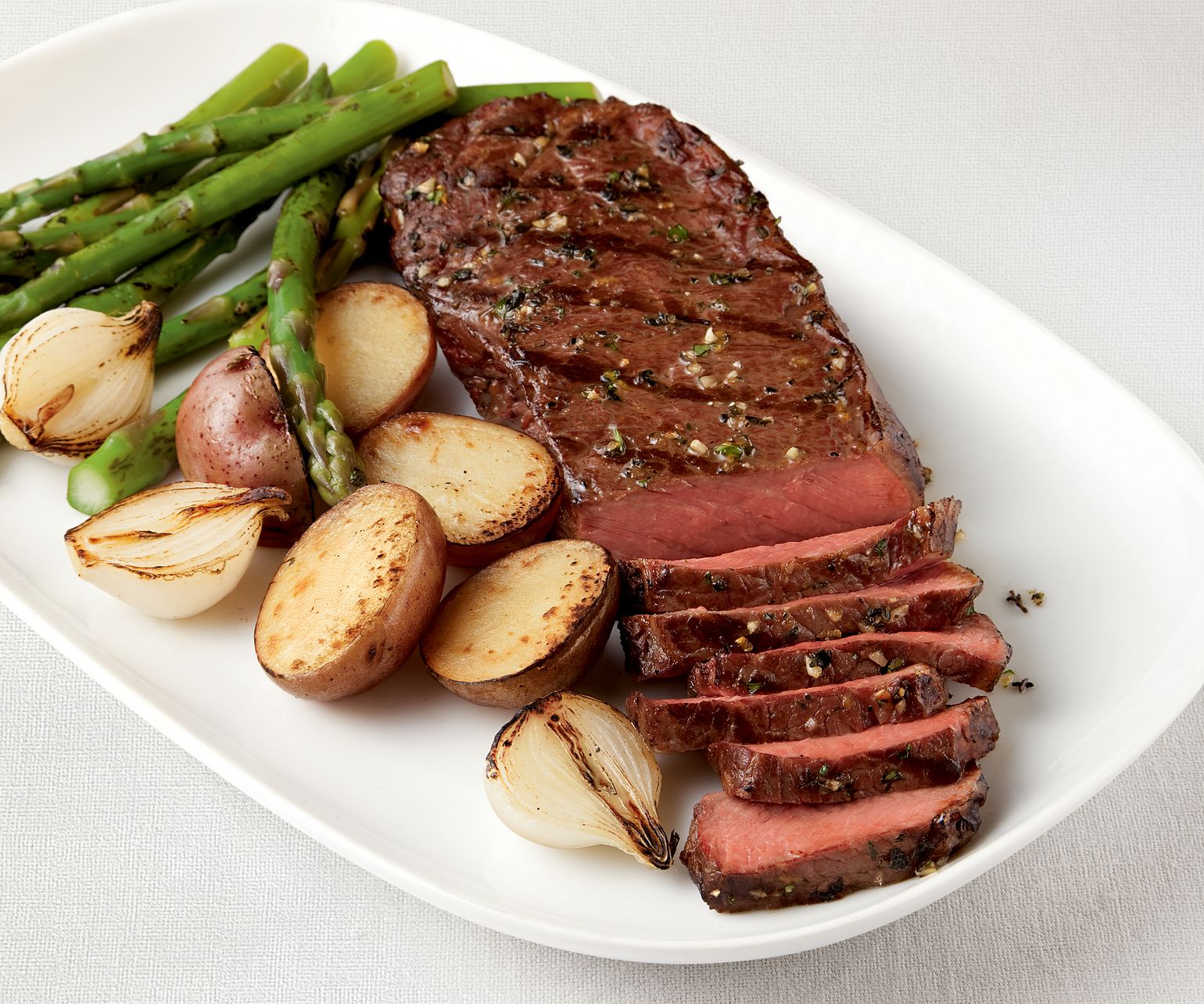 Tender Pepper-Rubbed Strip Steaks with Grilled Vegetable Trio