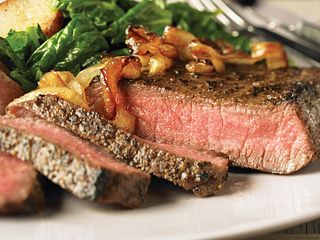 Peppered Beef Steaks with Caramelized Onions