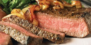 Peppered Beef Steaks with Caramelized Onions
