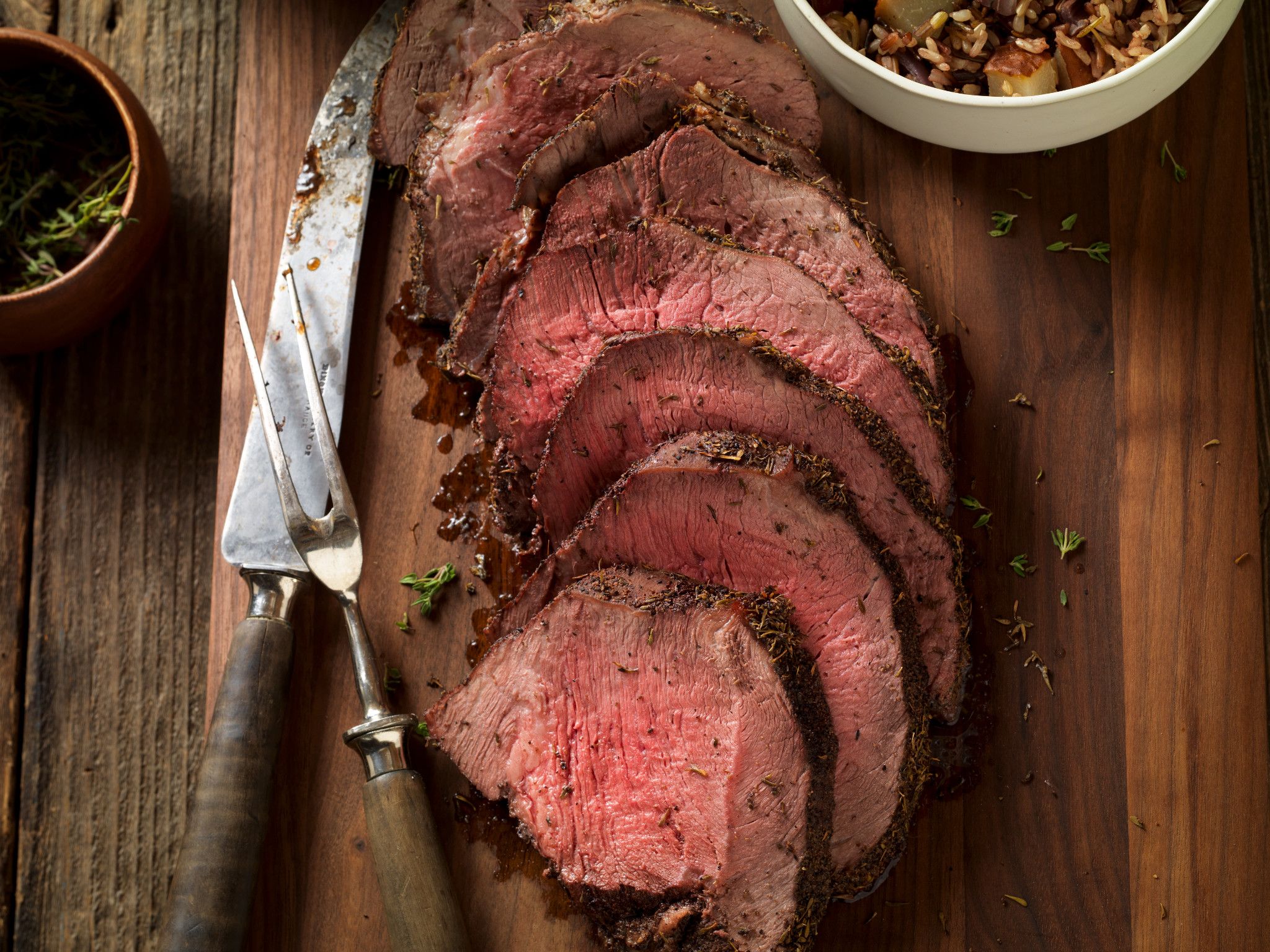 Thyme-Rubbed Beef Sirloin Tip Roast with Roasted Onion and Pear Wild Rice