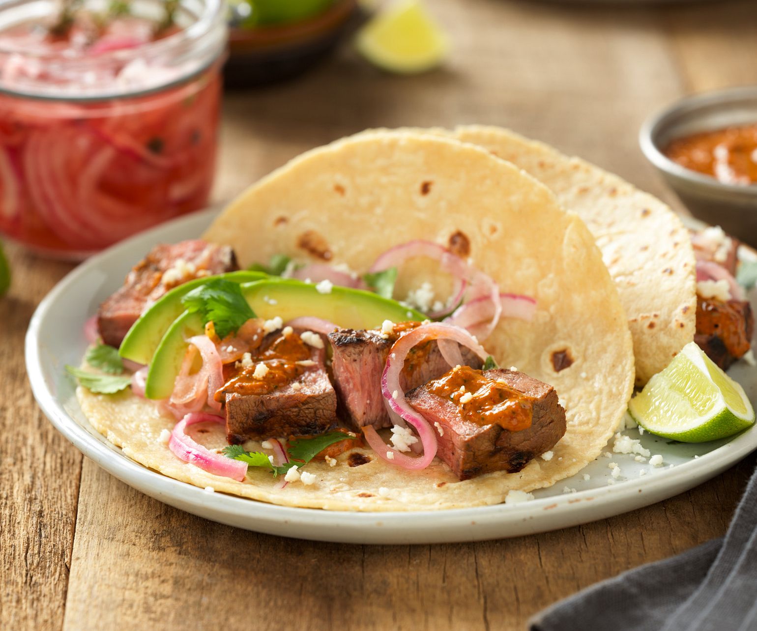 Grilled Adobo Beef Steak Tacos with Creamy Chipotle Salsa and Tequila Pickled Red Onions