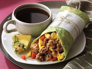Ground Beef, peppers and onions are quickly sautéed and wrapped up with scrambled eggs. Serve with lime-cilantro cream and salsa.