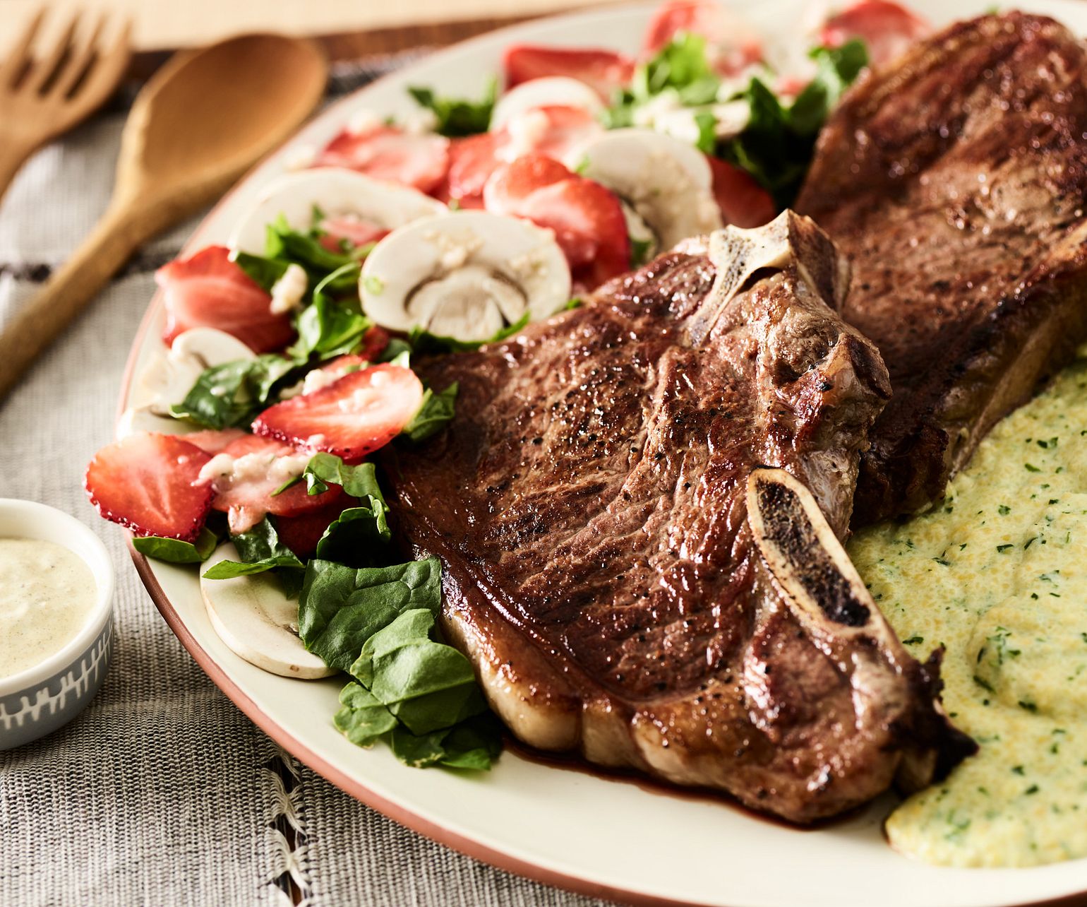 Beef Strip Steaks with Kale Polenta and Mushroom-Strawberry Salad