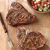 Greek-Seasoned T-Bone Steaks with Cucumber and Tomato Salad