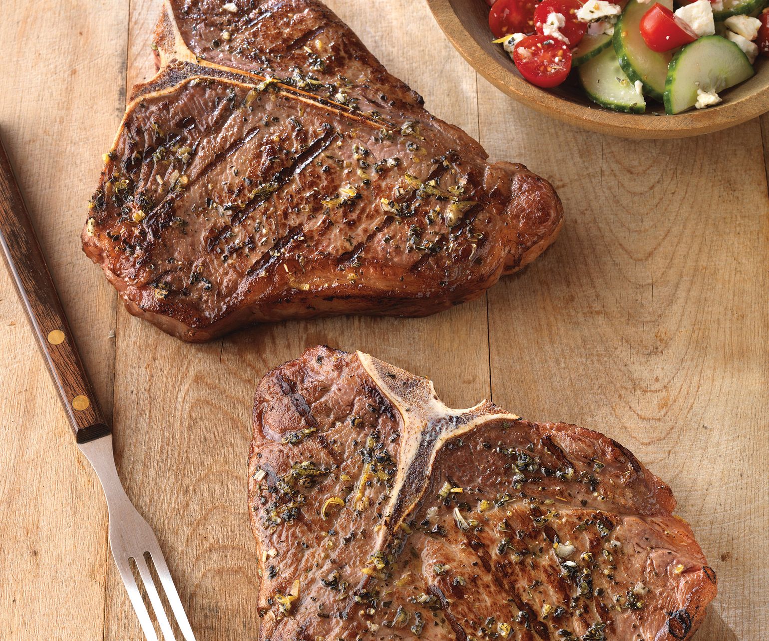 Greek-Seasoned T-Bone Steaks with Cucumber and Tomato Salad