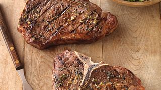 Greek-Seasoned T-Bone Steaks with Cucumber and Tomato Salad