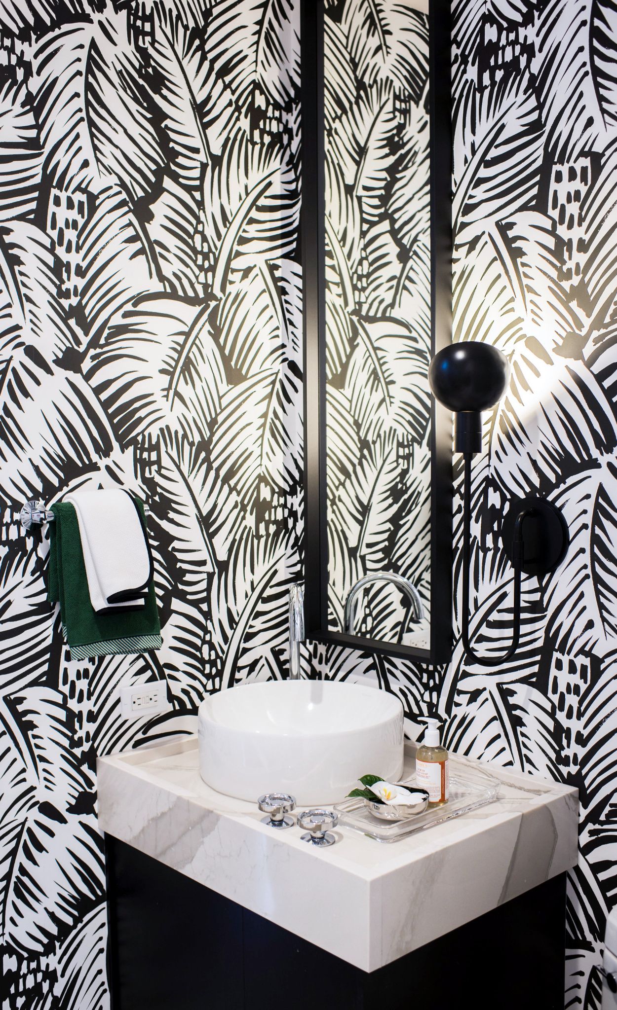 Bold wallpaper creates a statement in this powder room with Brittanicca Warm.