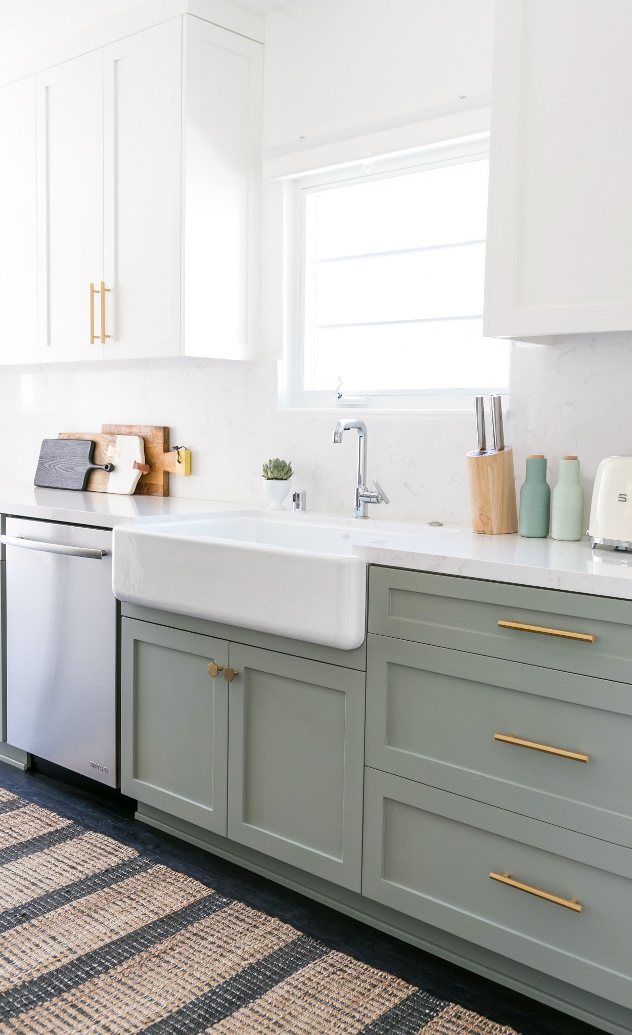 Green cabinets paired with brass accents and Cambria Torquay countertops and backsplash.