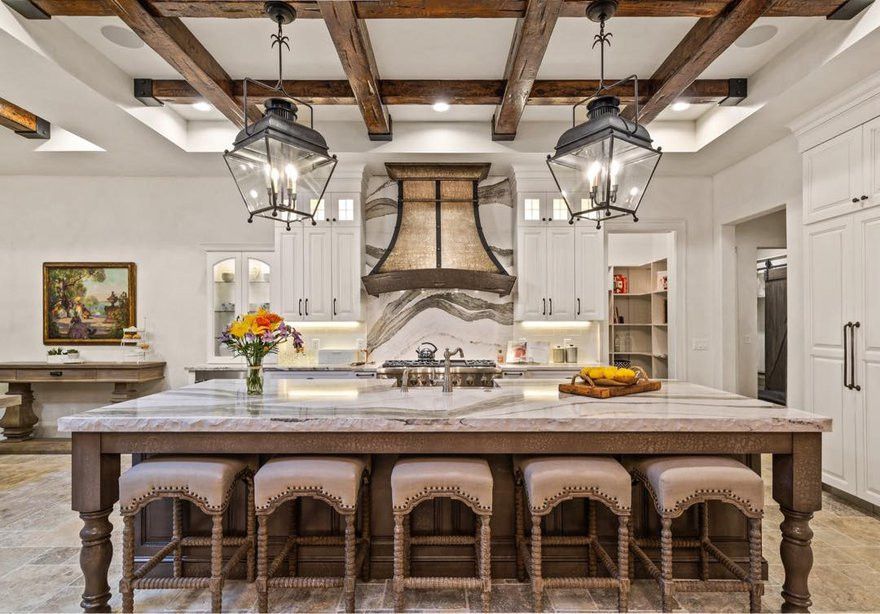 A full height range backsplash of Cambria Skara Brae and a chiseled edge island.