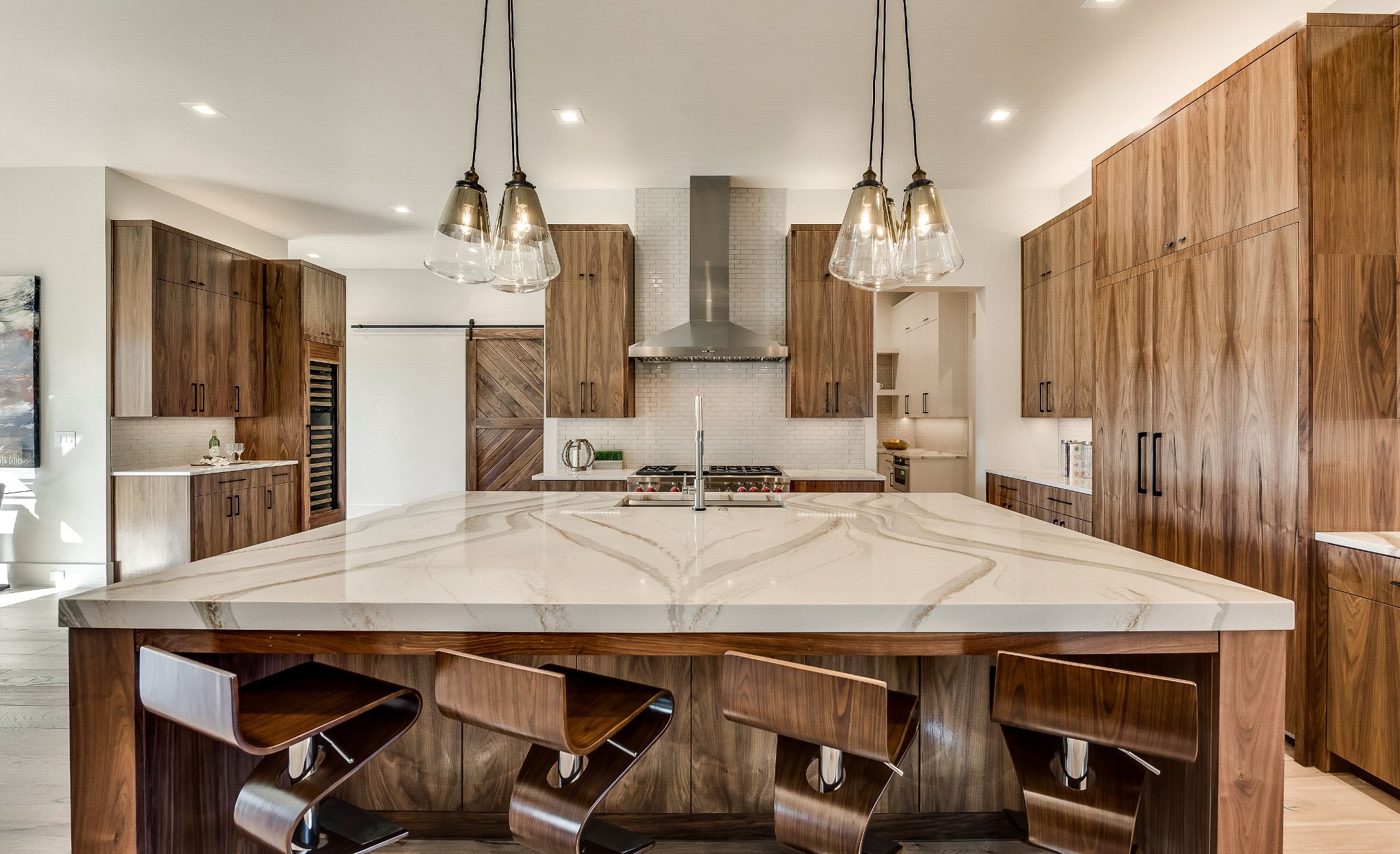 Gold marble-look quartz countertops paired with natural wood cabinets.