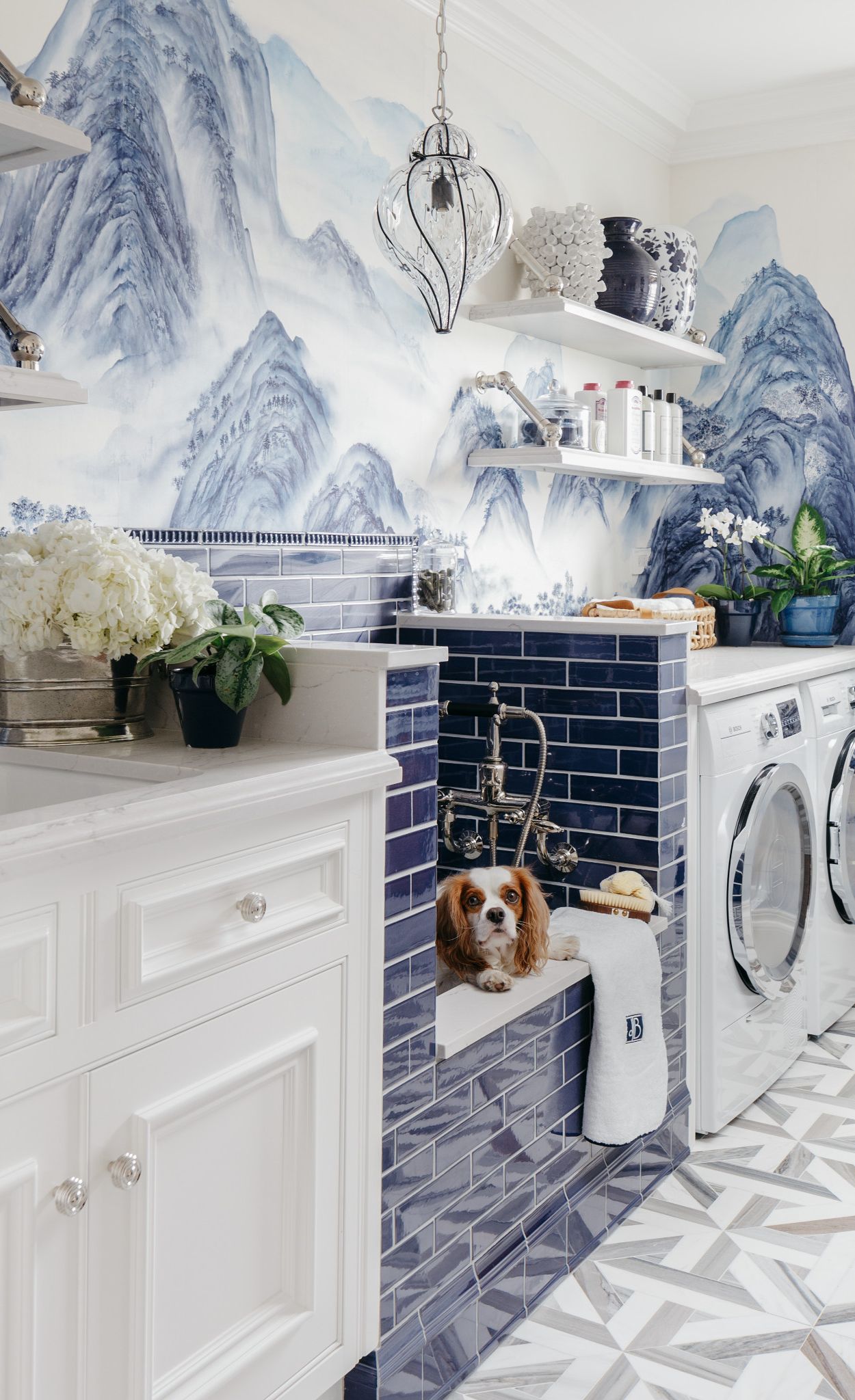 Laundry room with blue tile and mural wallpaper with Cambria Ella countertops.