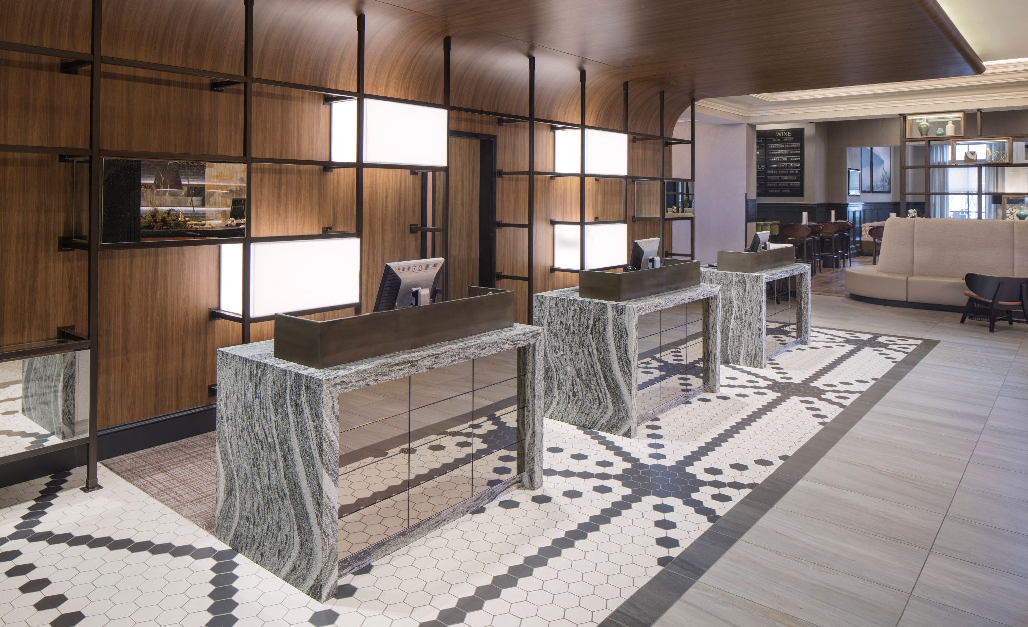 Hotel reception desk stations featuring waterfall-edge Cambria Roxwell countertops at Renaissance Minneapolis Hotel.