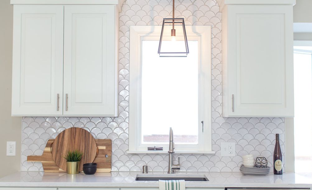 Add character with mermaid tile and Cambria Swanbridge countertops.