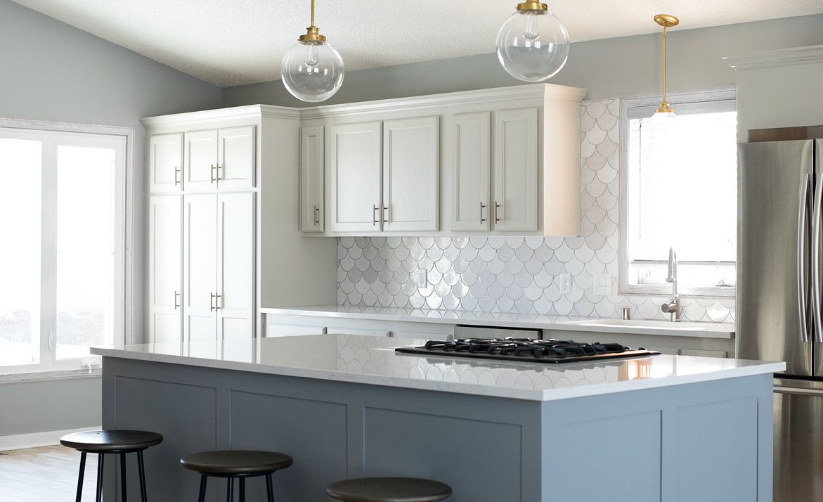 Pair Cambria Swanbridge, mermaid tile, and gray cabinetry to create a family-friendly kitchen.