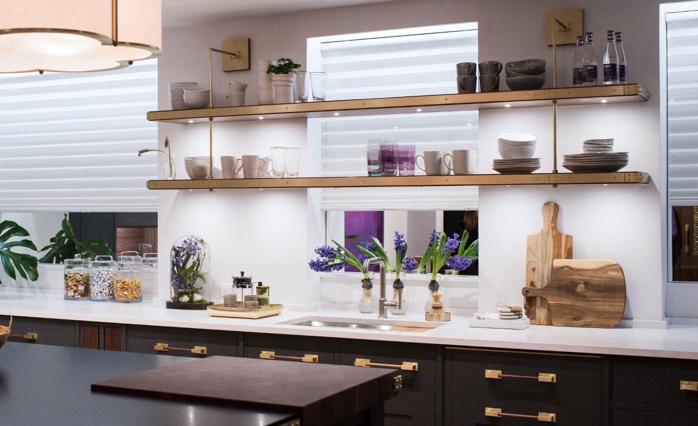 Brass detailed, open shelving provides airy feel to the space.