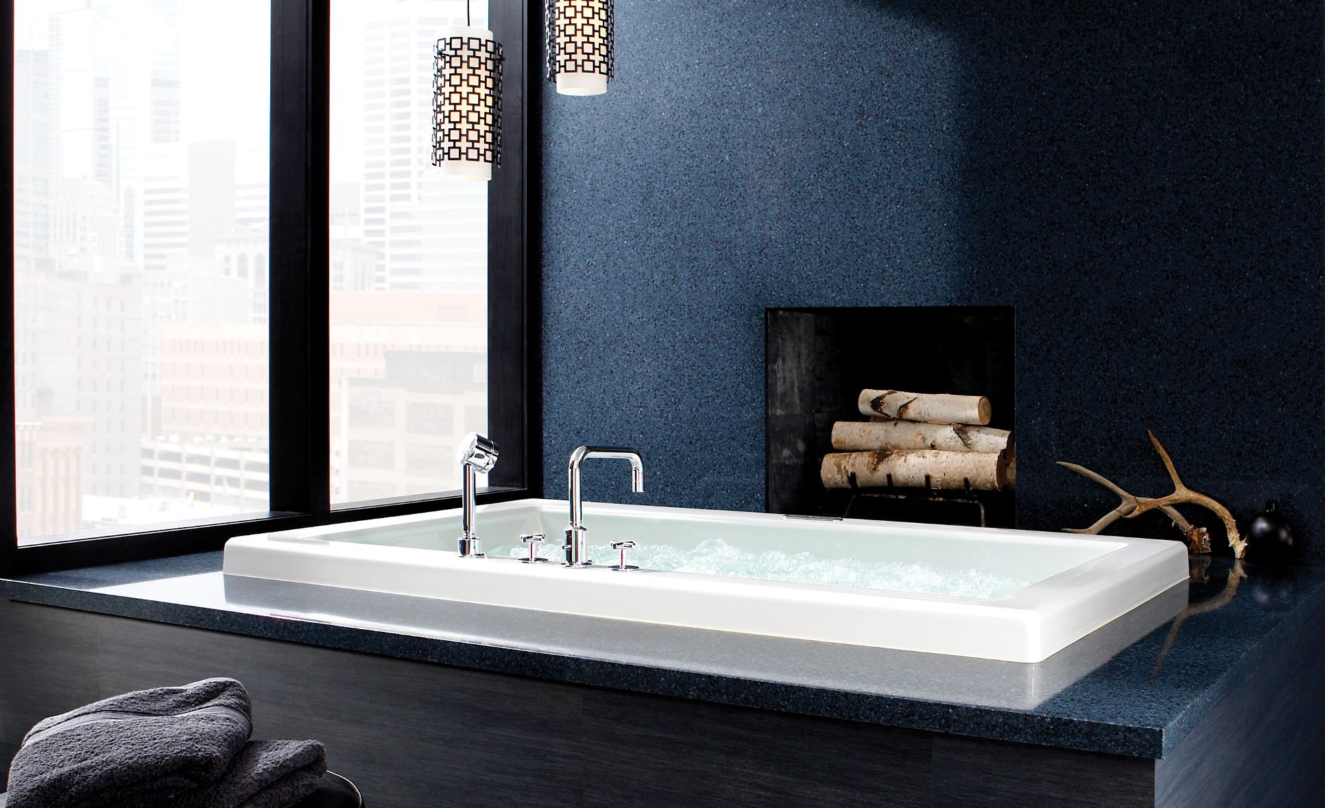 Spa-like tub surround and fireplace feature Cambria Bristol Blue.