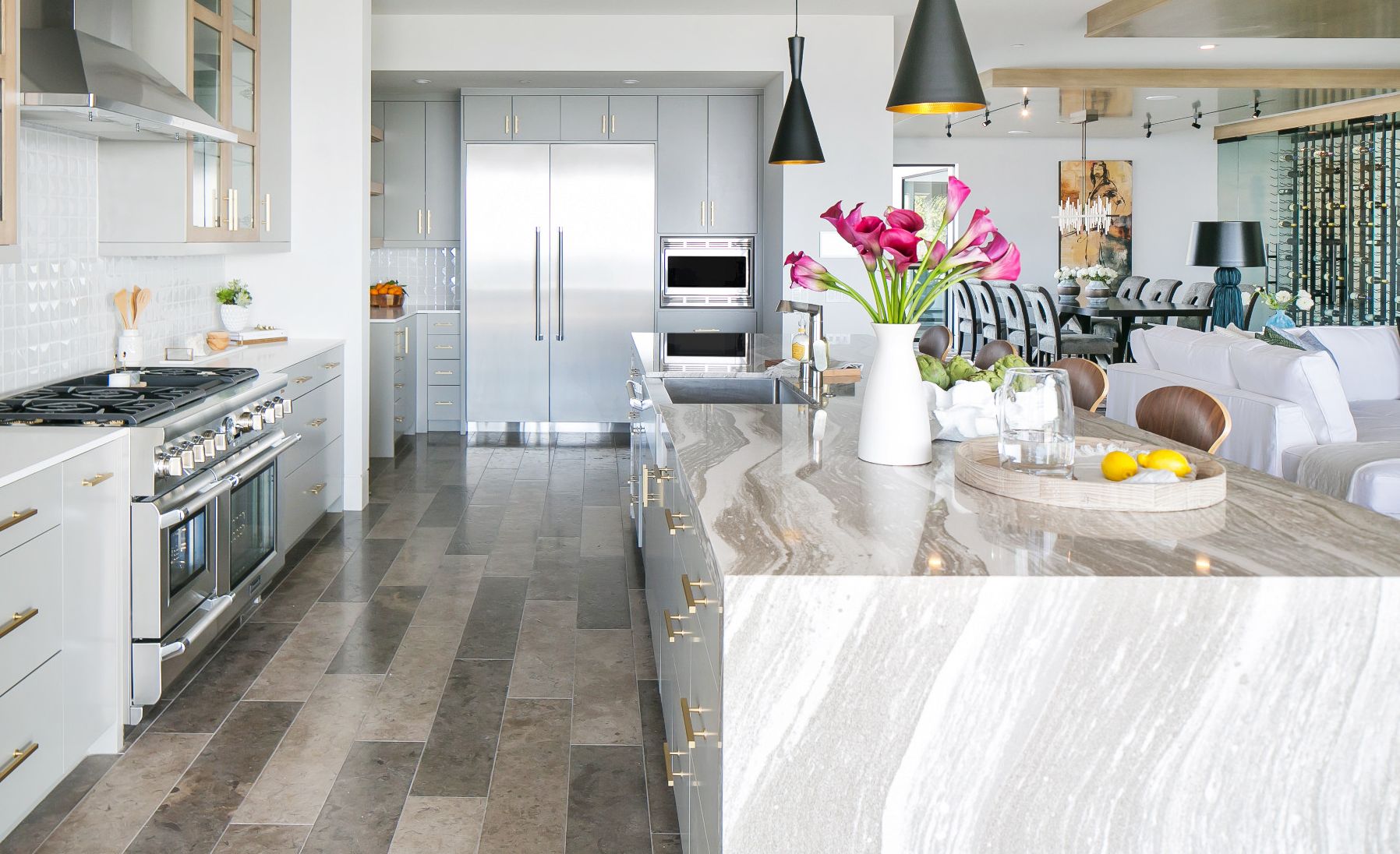 Stunning coastal kitchen featuring a waterfall island made of the wood countertop alternative, Cambria Oakmoor.