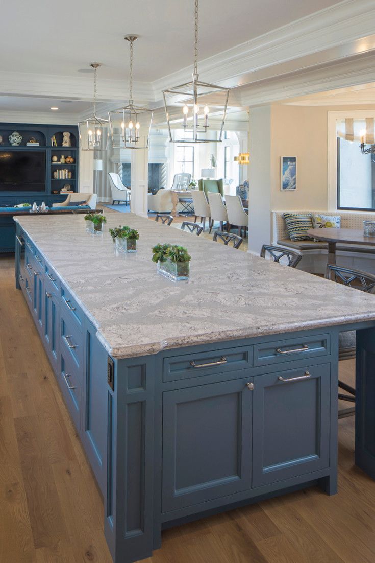 A spacious Cambria Summerhill island and blue-gray cabinetry are the perfect combination in this kitchen.