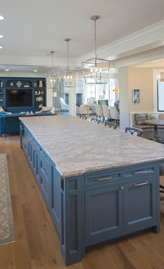 A spacious Cambria Summerhill island and blue-gray cabinetry are the perfect combination in this kitchen.