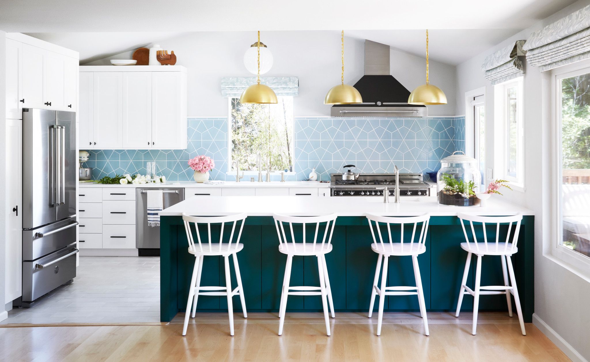 Dark blue kitchen island paired with Cambria White Cliff.