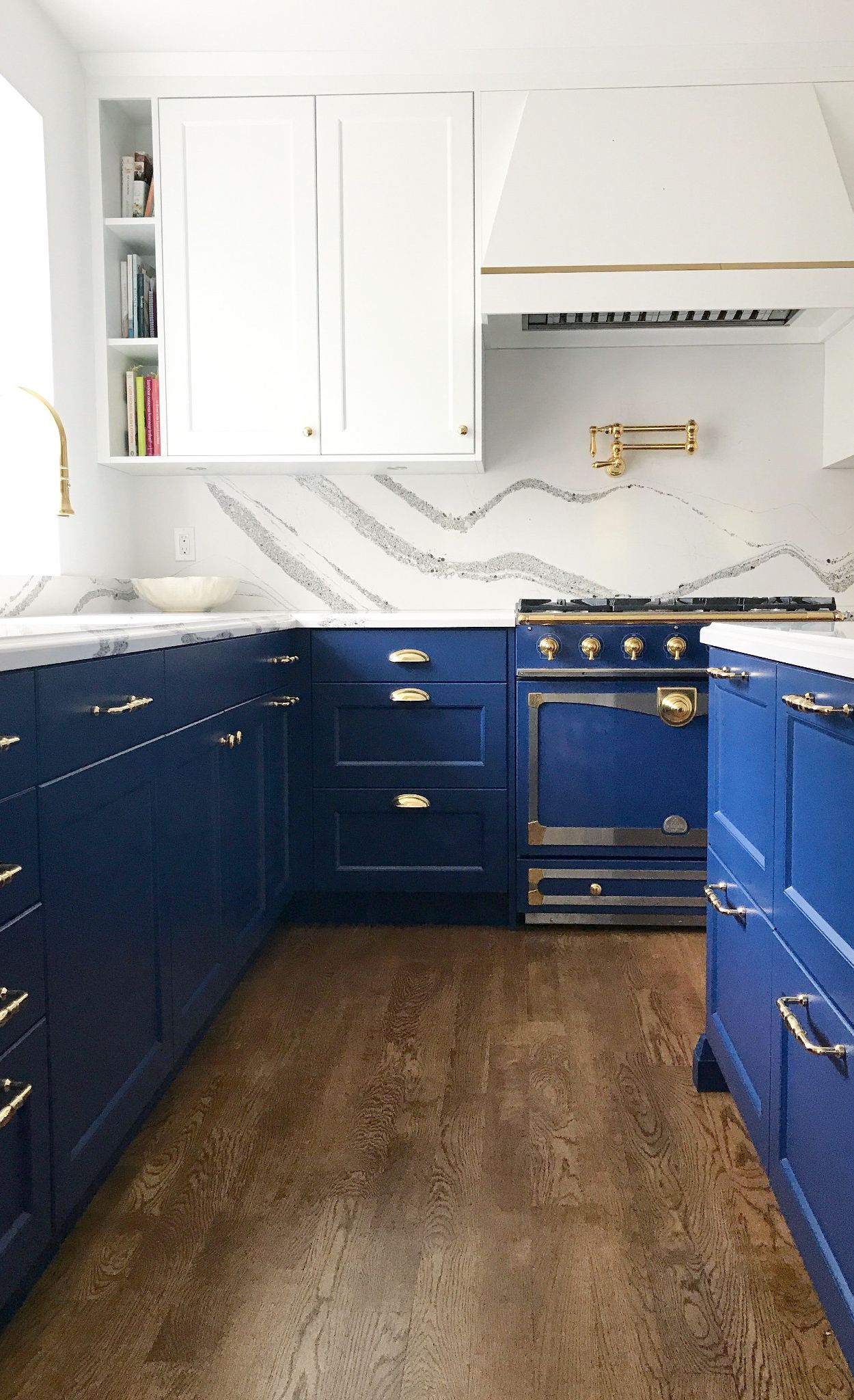 Blue cabinets and blue appliances paired with Cambria Annicca countertop and backsplash.
