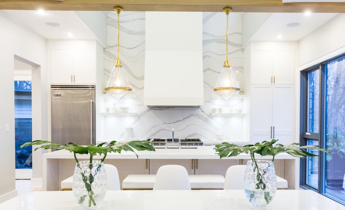 The bold movement of a Cambria Brittanicca backsplash contrasts crisp, monochromatic White Cliff countertops.