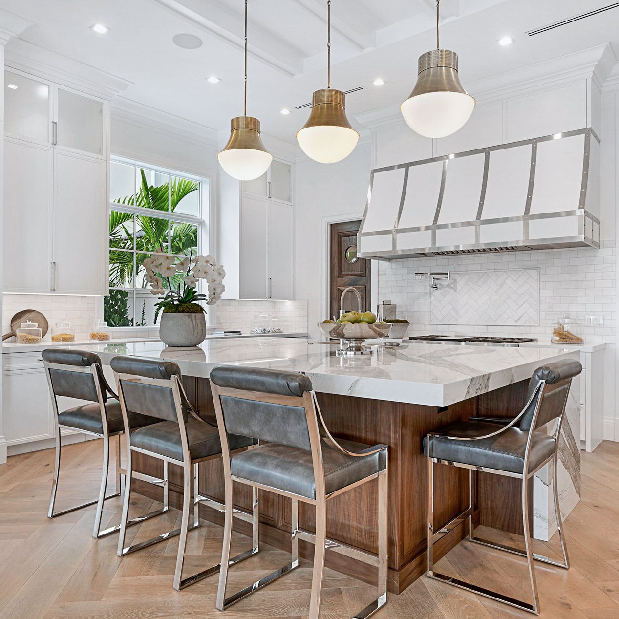 Cambria Skara Brae in a white kitchen with wood island cabinets.