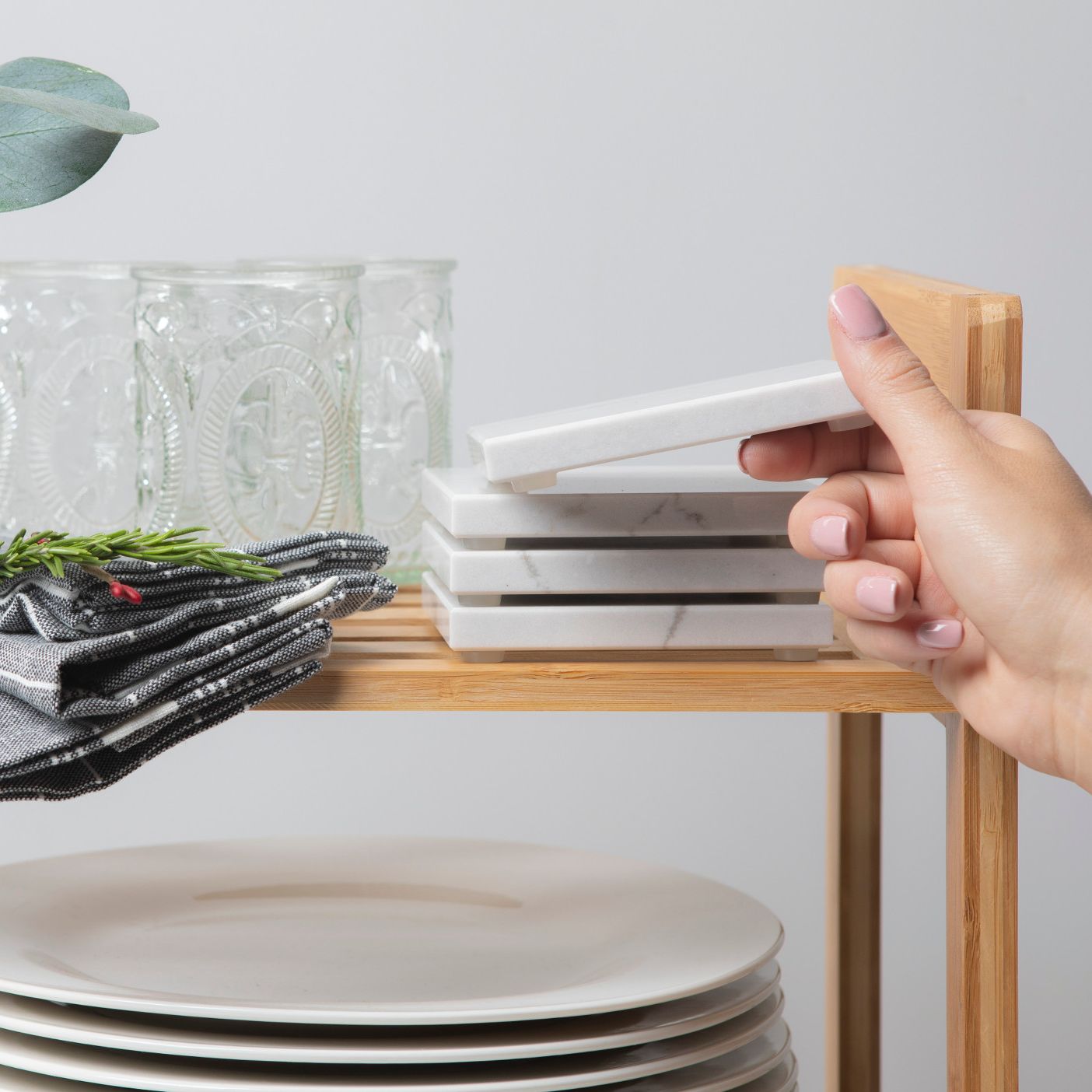 Cambria coasters being stacked on a shelf.
