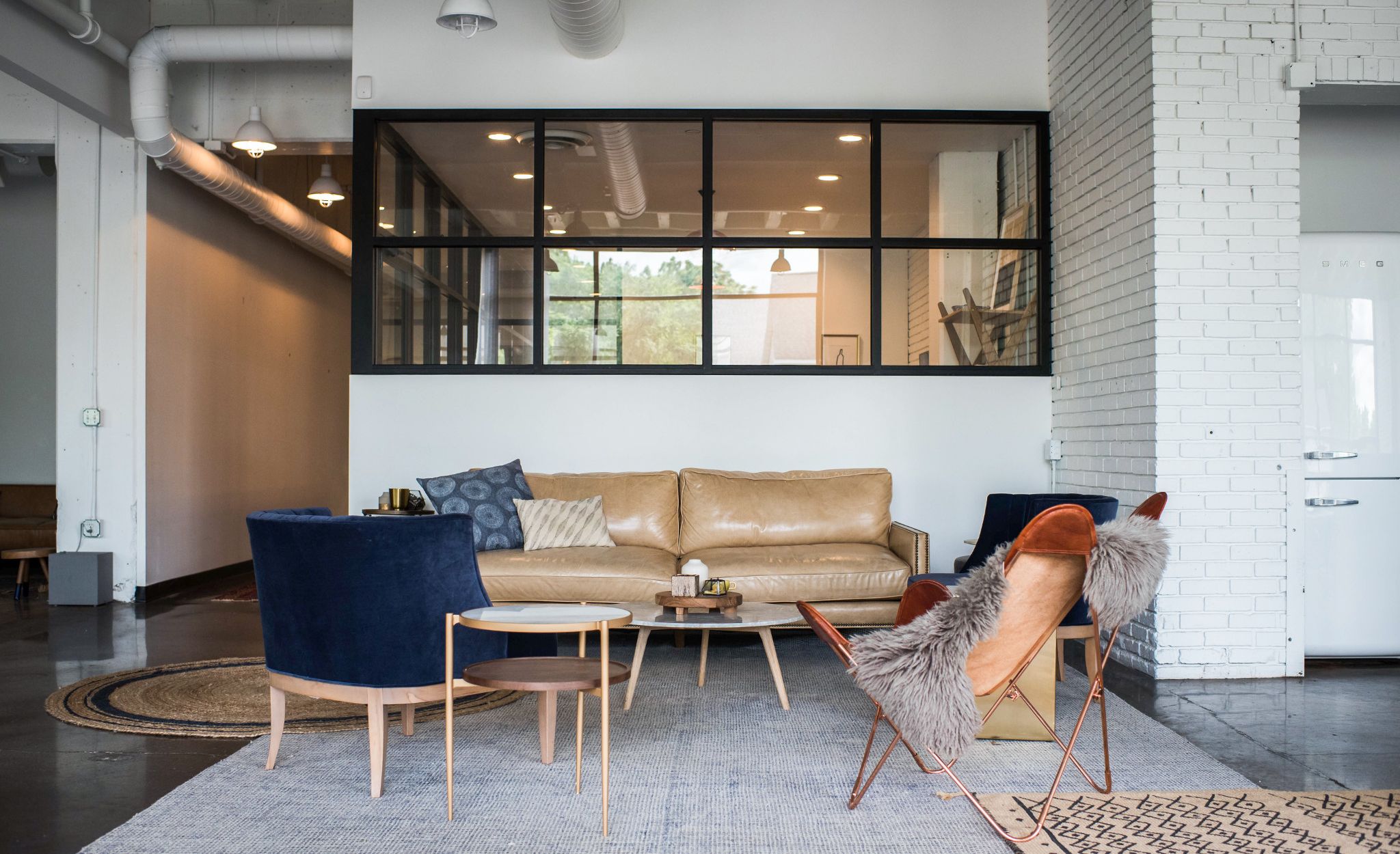 Lounge furniture offers a more casual gathering place outside the conference room.