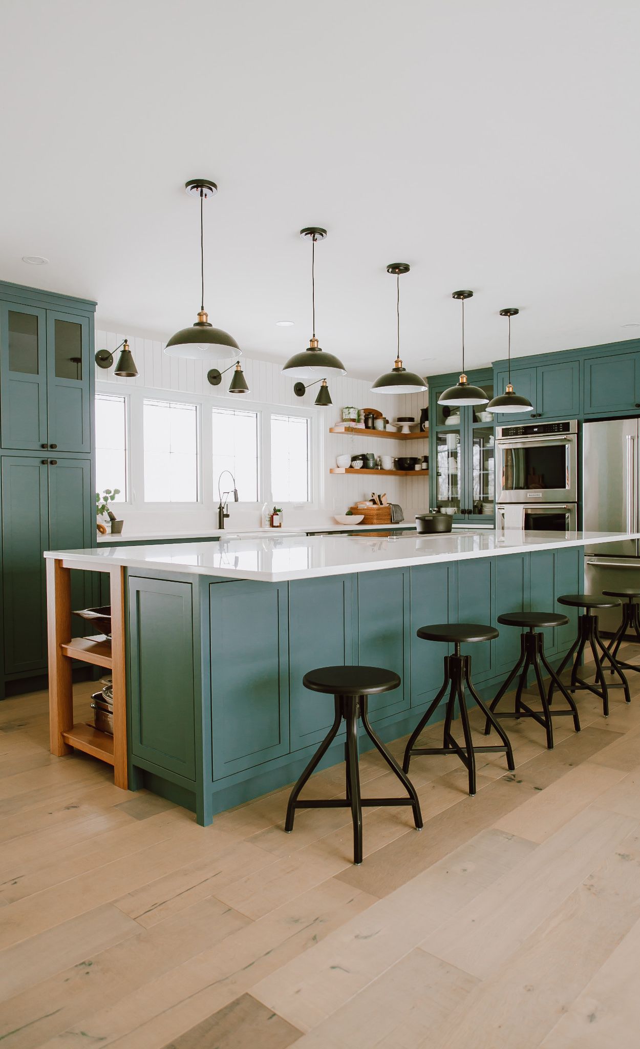 Fresh green tones paired with light, natural wood flooring and Newport countertops.