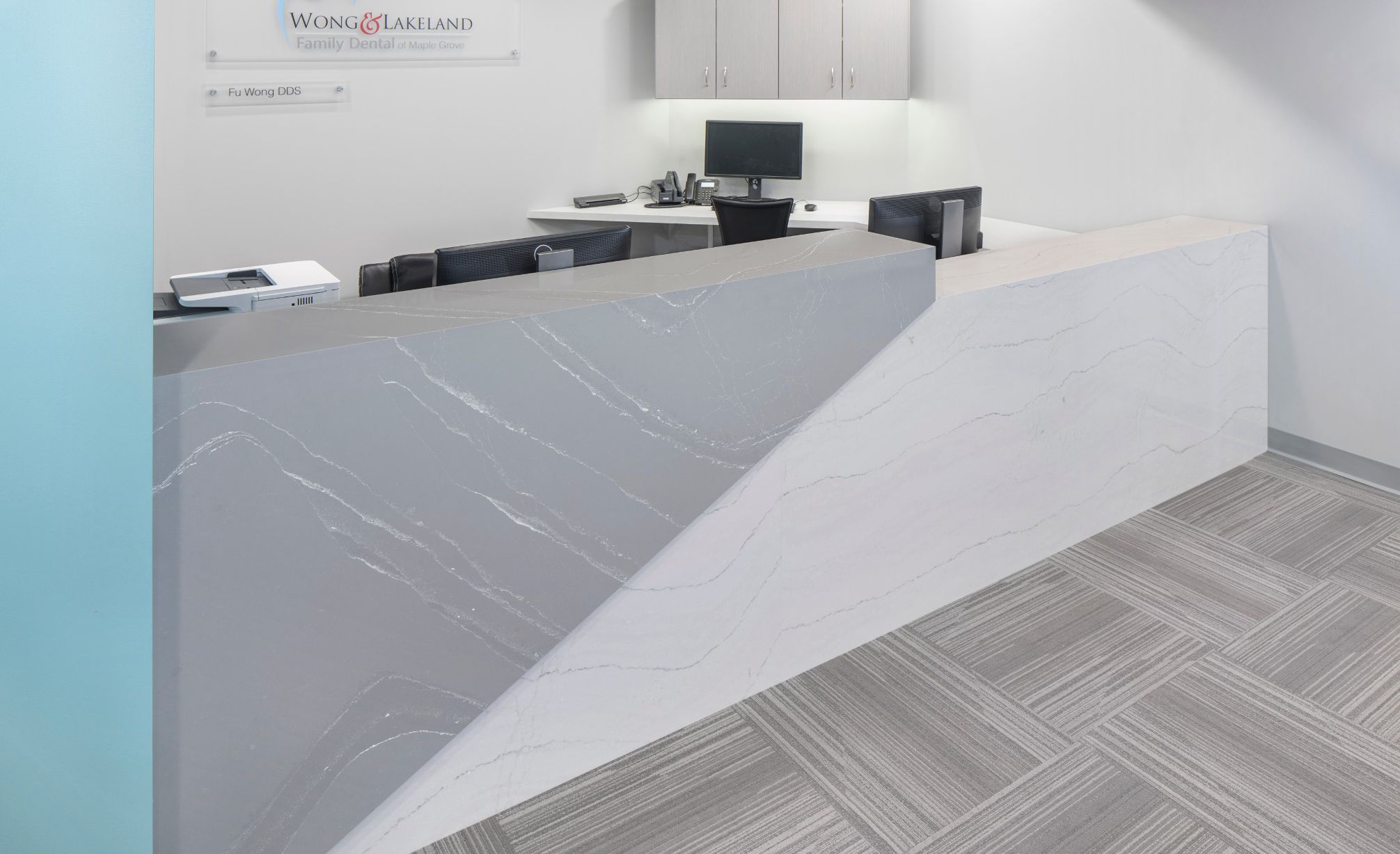 Dentist office reception desk featuring Cambria Queen Anne Matte and Cambria Ella Matte.