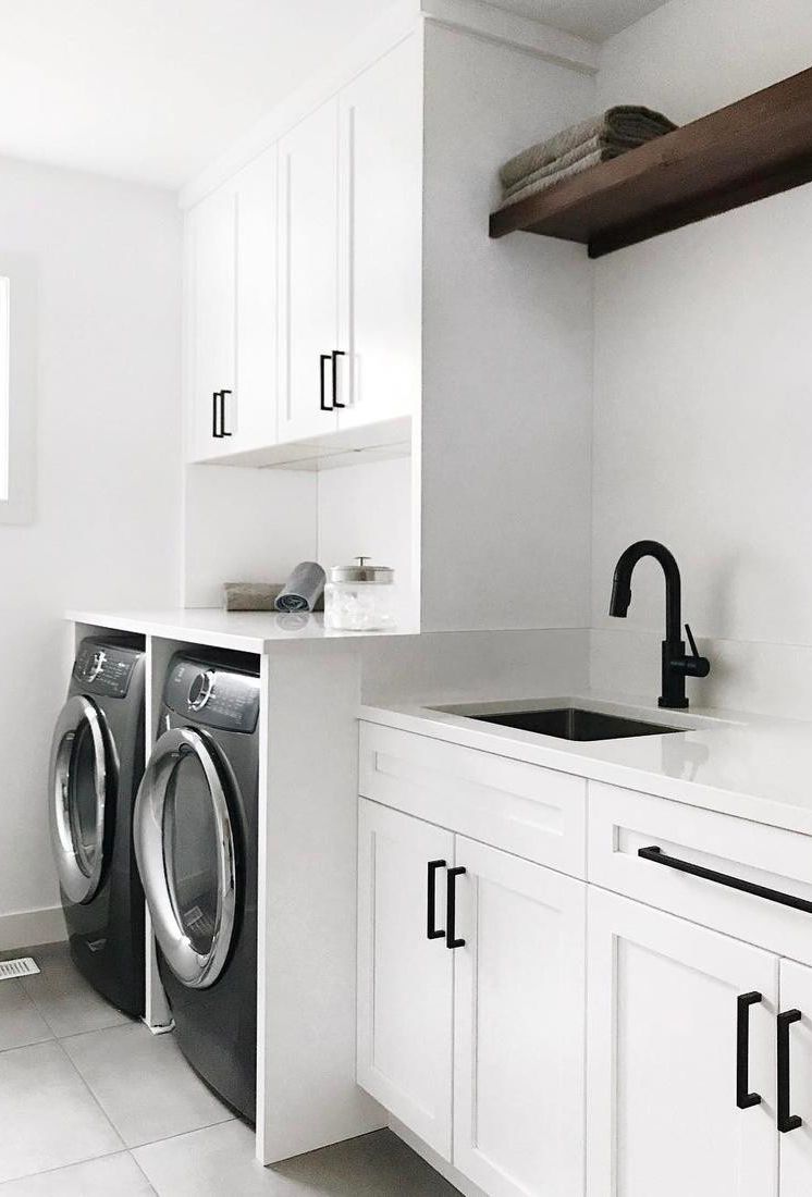 Cambria White Cliff countertops in an all white and black laundry room.