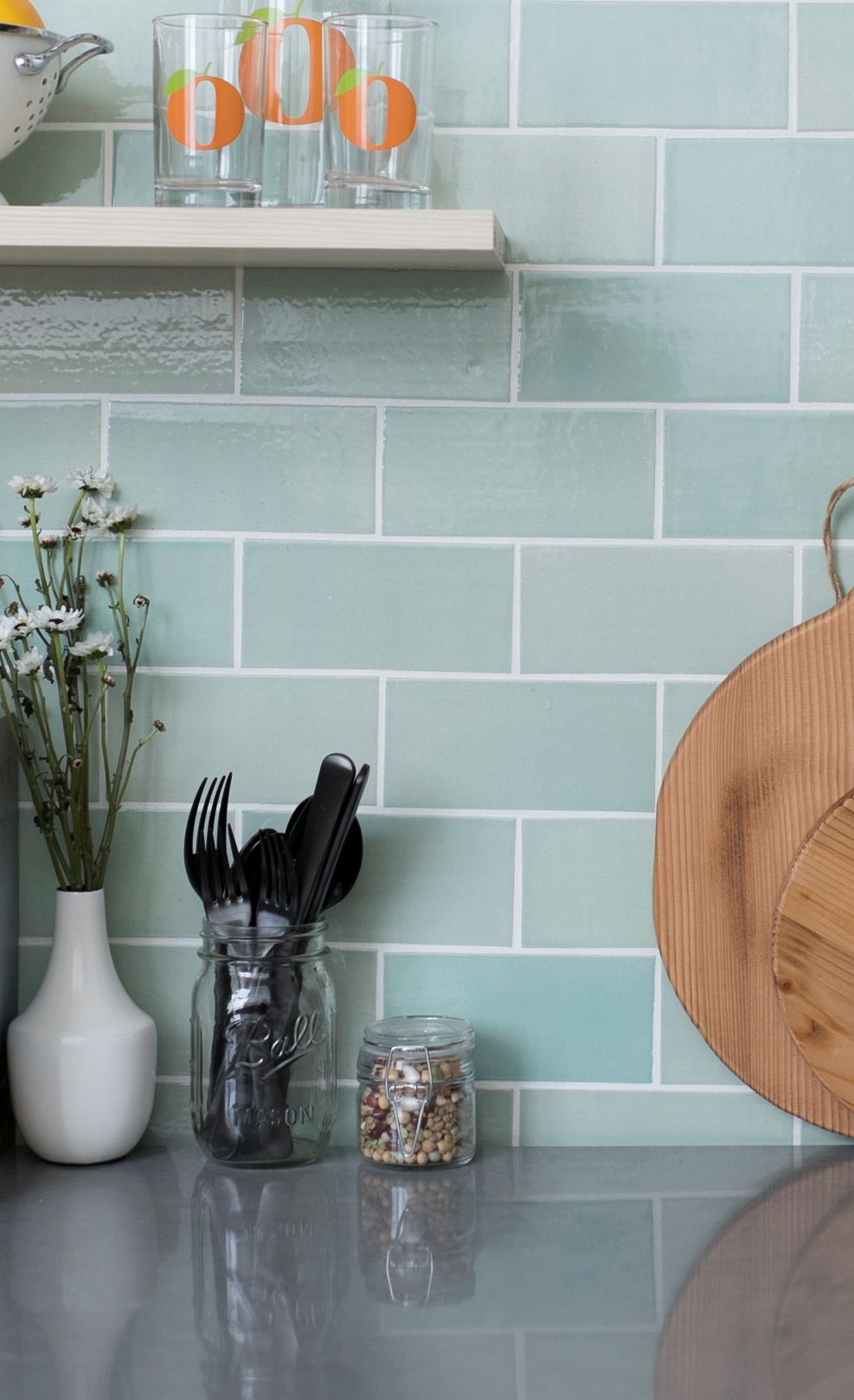 Blue-green subway tiles paired with Cambria Carrick.
