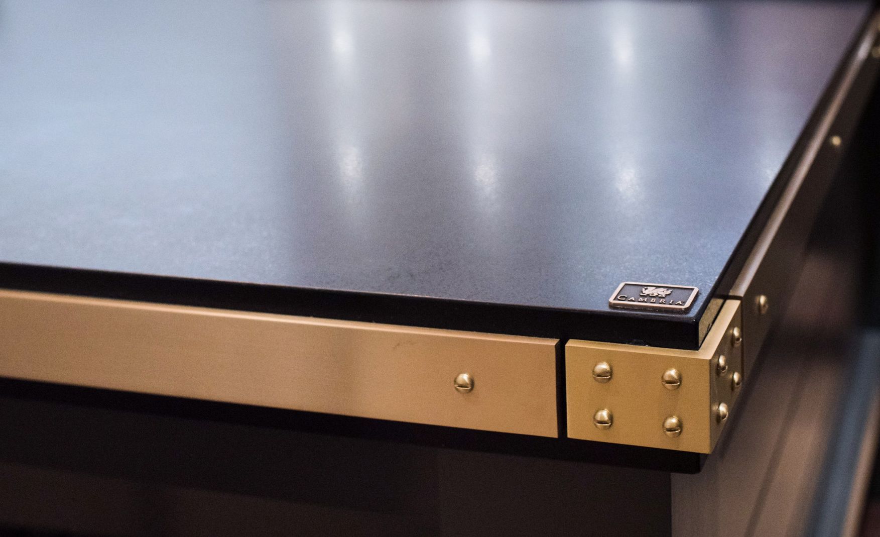 Cambria Blackpool Matte countertops with a brass band edge detail.