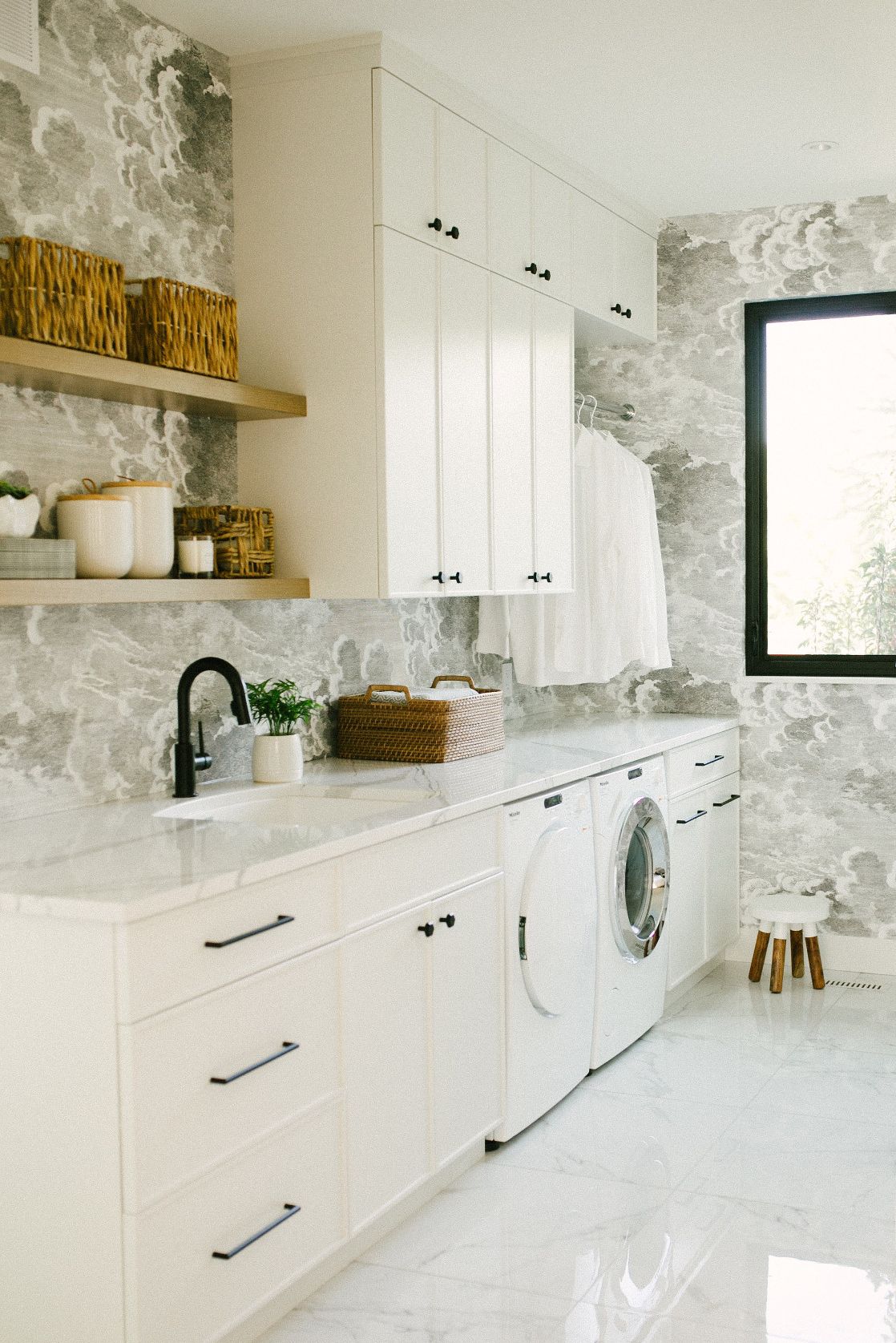 Cambria Brittanicca paired with white cabinets and matte black accents in a laundry room.