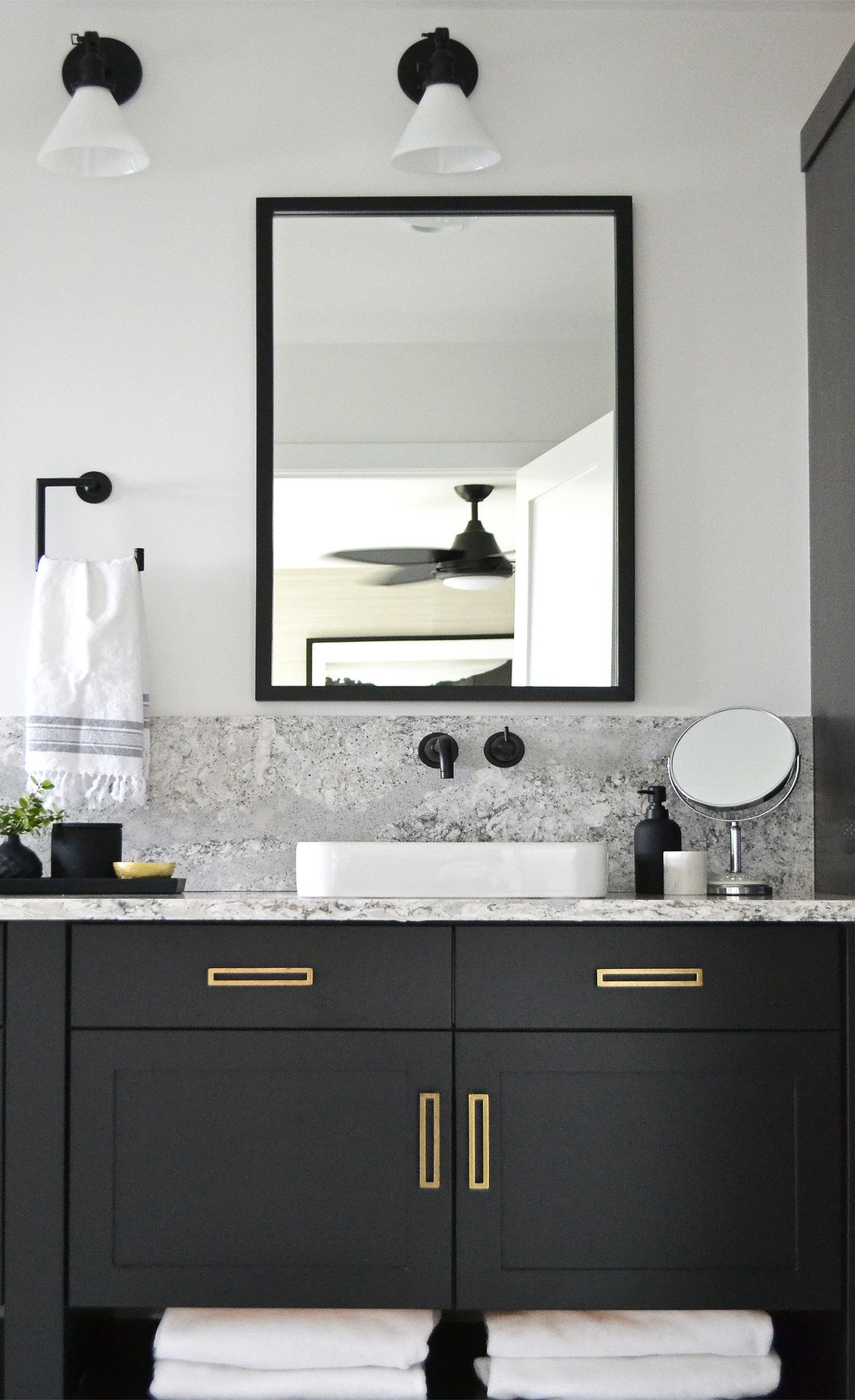 Cambria Summerhill  adds a pop of pattern to this matte black bathroom.
