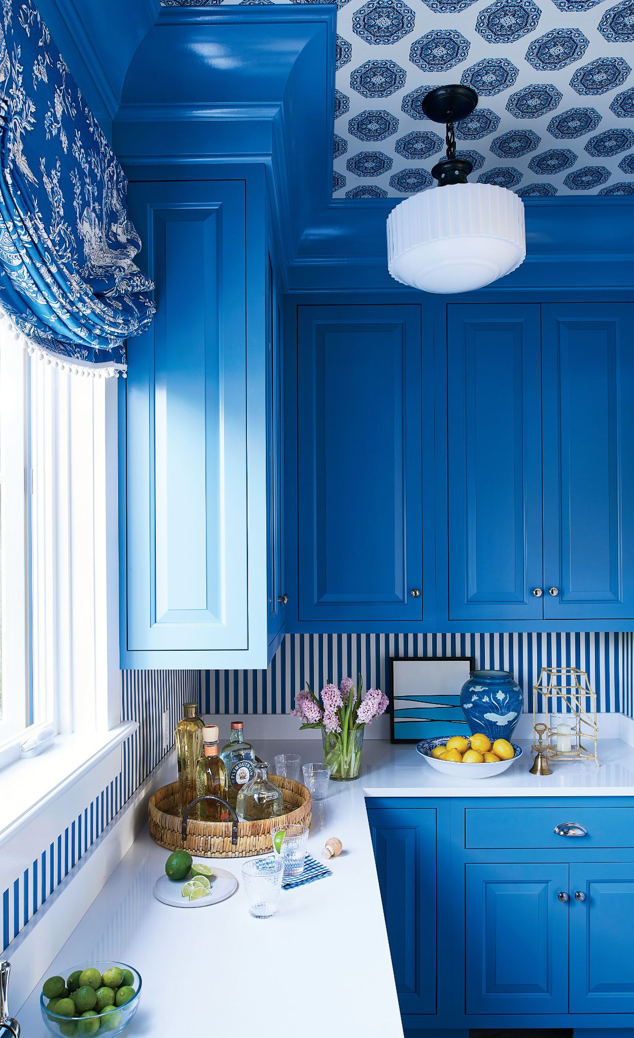 Vibrant cobalt cabinets pair with Cambria White Cliff.