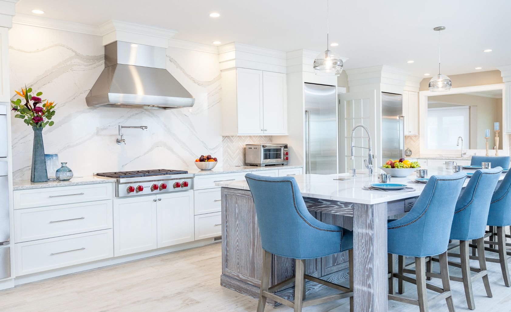 Cambria Brittanicca kitchen island and backsplash with blue stools.