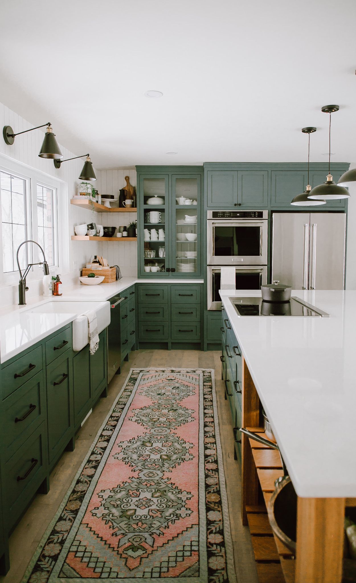 Green and white farmhouse kitchen with Cambria Newport™.