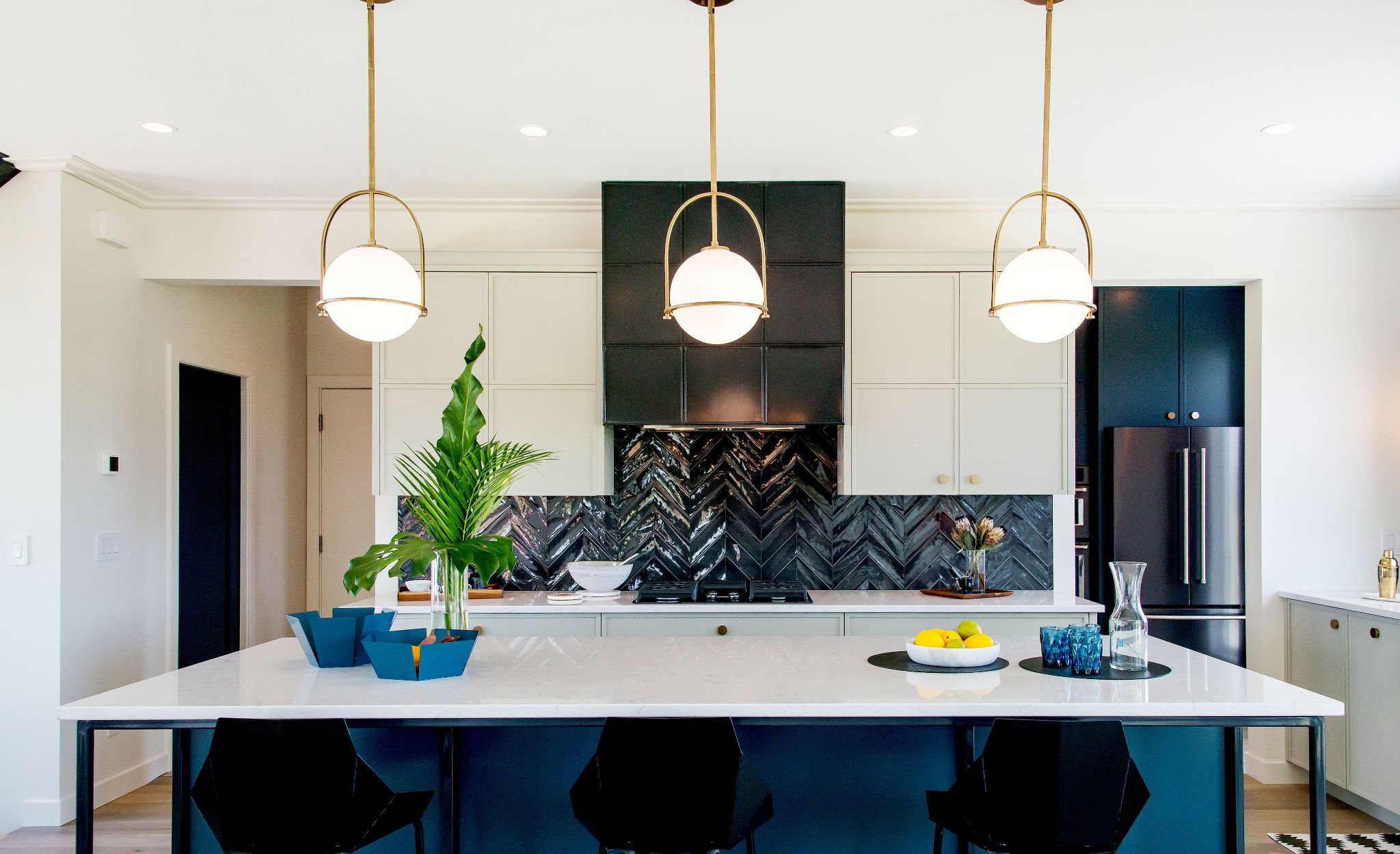 Blue, black, and white kitchen featuring Cambria Swanbridge.