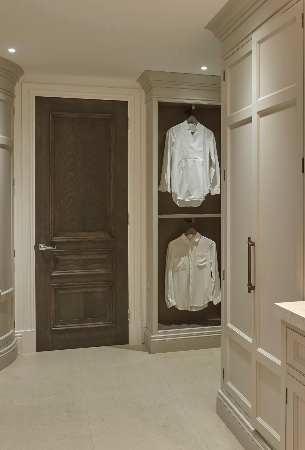 a greige laundry and utility room with Cambria Quartz Swanbridge countertops and plenty of space to hang and store clothing.